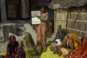 Woman in Nepal leads a training on raising healthy livestock.