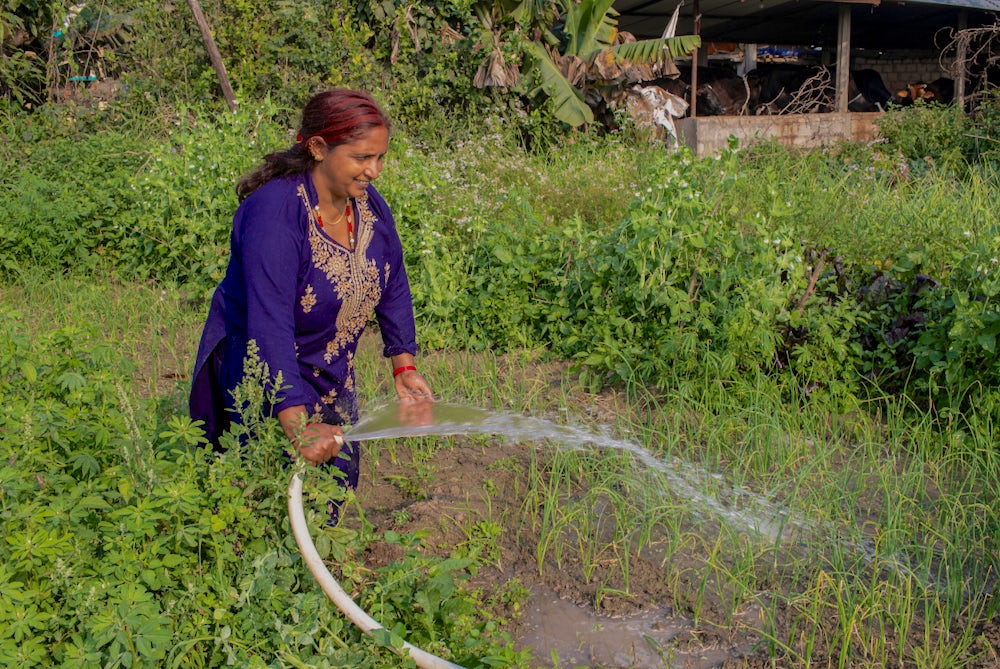Kamala Poudel works in her kitchen garden.