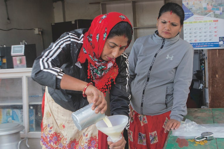 Women preparing milk bottles.