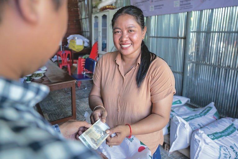 A farmer completes a transaction.