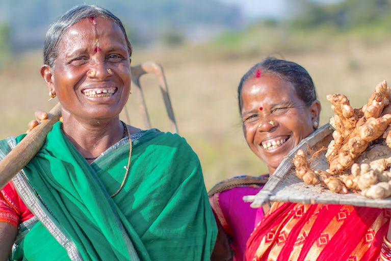 Women farmers holding ginger.