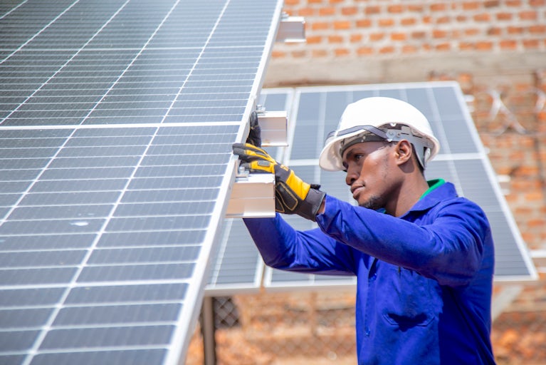 Technician working on solar panel.