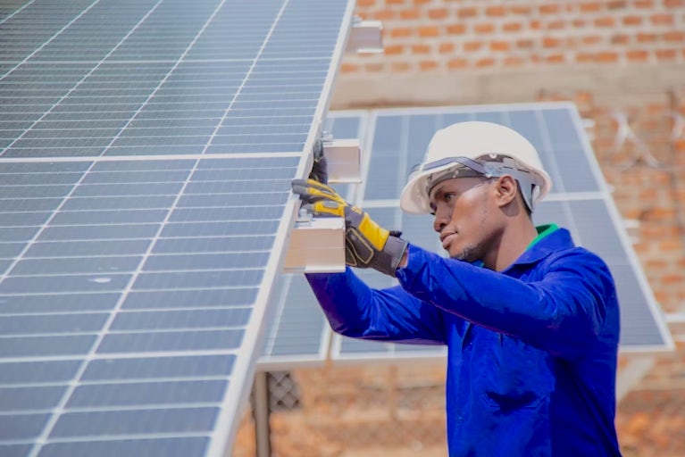 An engineer installing a solar panel