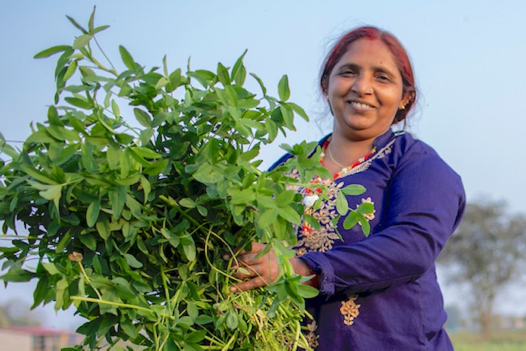 woman holding plant.